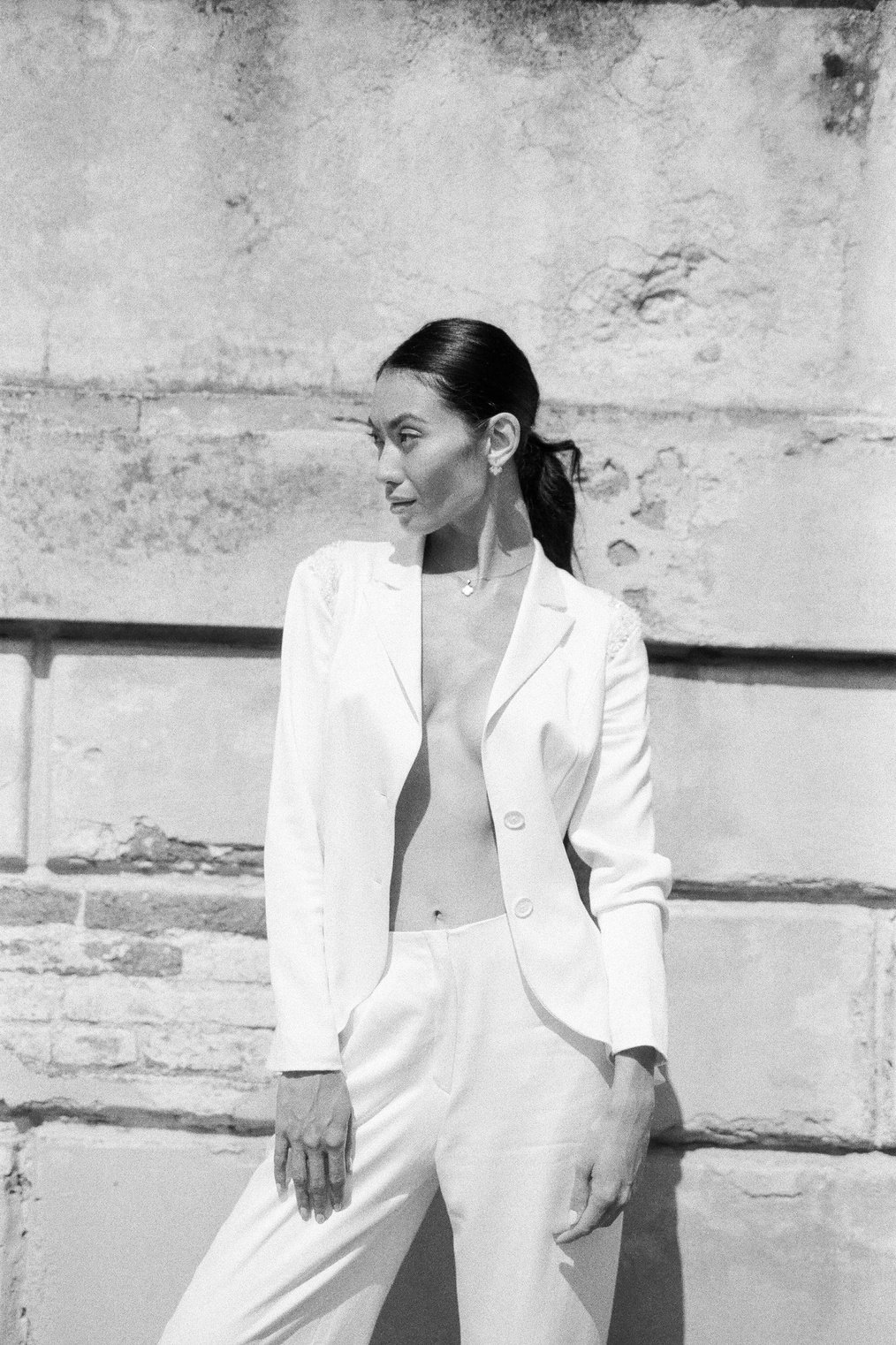 Woman in White Blazer Standing Near Wall